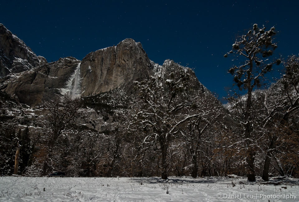 Frozen Yosemite Falls under a starry sky.